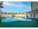 Inviting kidney-shaped pool with a wooden pergola and artificial turf at 610 Alton Rd, Winter Springs, FL 32708