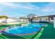 Relaxing kidney-shaped pool with a wooden pergola, artificial turf, and backyard at 610 Alton Rd, Winter Springs, FL 32708