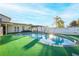 Stunning kidney-shaped pool with a wooden pergola and lush green grass at 610 Alton Rd, Winter Springs, FL 32708