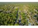 A wide aerial shot of a residential area, showing the layout of homes and the surrounding landscape at 765 W Lansdowne Ave, Orange City, FL 32763