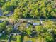 Expansive aerial view of a home surrounded by lush greenery and mature trees at 765 W Lansdowne Ave, Orange City, FL 32763