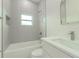 Modern bathroom featuring a sleek vanity, stylish shower, and a bright window at 765 W Lansdowne Ave, Orange City, FL 32763