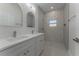 Stylish bathroom featuring double sinks, modern fixtures, and decorative tile shower at 765 W Lansdowne Ave, Orange City, FL 32763