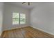Bright bedroom with wood-look floors and a large window offering plenty of natural light at 765 W Lansdowne Ave, Orange City, FL 32763