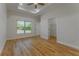 Bedroom featuring wood-look floors, tray ceiling, large window, and walk-in closet at 765 W Lansdowne Ave, Orange City, FL 32763