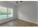 Cozy bedroom with wood-look flooring and a bright window overlooking the outdoors at 765 W Lansdowne Ave, Orange City, FL 32763