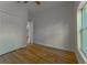 Bedroom with wood floors, a closet, and a window, offering a serene and bright space at 765 W Lansdowne Ave, Orange City, FL 32763