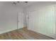 Bedroom with wood-look floors, white walls, and a closet for ample storage space at 765 W Lansdowne Ave, Orange City, FL 32763