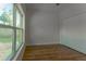 Bright bedroom features wood-look floors and a large window overlooking the backyard at 765 W Lansdowne Ave, Orange City, FL 32763