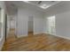 Bedroom featuring wood-look floors, tray ceiling, ensuite bath, and walk-in closet at 765 W Lansdowne Ave, Orange City, FL 32763
