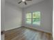 Bright, airy bedroom with wood-look flooring and a large window offering natural light at 765 W Lansdowne Ave, Orange City, FL 32763