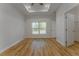 Bedroom featuring wood-look floors, tray ceiling, large window, and walk-in closet at 765 W Lansdowne Ave, Orange City, FL 32763