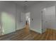 Bedroom featuring wood-look flooring, white walls, and open doors leading to other rooms at 765 W Lansdowne Ave, Orange City, FL 32763