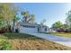 Charming single-story home with a concrete driveway and a well-maintained lawn at 765 W Lansdowne Ave, Orange City, FL 32763