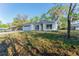 Cozy single-Gathering home featuring an attached garage and a green front lawn at 765 W Lansdowne Ave, Orange City, FL 32763