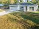 A beautifully renovated home with an attached two-car garage on a well-manicured lawn at 765 W Lansdowne Ave, Orange City, FL 32763