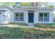 Charming home with a vibrant blue door, contrasting trim, and a manicured front lawn at 765 W Lansdowne Ave, Orange City, FL 32763
