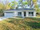 Well-maintained single-story house with a two car garage and tidy landscaping at 765 W Lansdowne Ave, Orange City, FL 32763