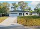 Beautifully renovated home with a well-manicured lawn and a spacious two-car garage at 765 W Lansdowne Ave, Orange City, FL 32763