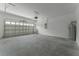 Spacious garage with neutral walls and concrete floors, ready for vehicles and storage at 765 W Lansdowne Ave, Orange City, FL 32763