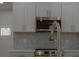 Beautiful kitchen details with stainless steel microwave and faucet and a patterned backsplash at 765 W Lansdowne Ave, Orange City, FL 32763
