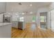 Bright, modern kitchen with stainless steel appliances and a breakfast bar island, seamlessly connected to the living area at 765 W Lansdowne Ave, Orange City, FL 32763