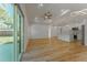 Open floor plan with modern wood flooring, recessed lighting, and sliding doors to backyard at 765 W Lansdowne Ave, Orange City, FL 32763