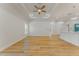 Expansive living room with tray ceilings and modern lighting, adjacent to the kitchen and dining area at 765 W Lansdowne Ave, Orange City, FL 32763