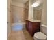 Bathroom featuring tile flooring, tub-shower combo, and a vanity with granite counters offering a refreshing retreat at 8343 Bella Tierra Ct # 8343, Davenport, FL 33896