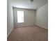 Bright bedroom features neutral carpet, light walls, and a window with blinds at 8343 Bella Tierra Ct # 8343, Davenport, FL 33896