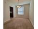Carpeted dining area with a chandelier and natural light, perfect for enjoying meals with Gathering and friends at 8343 Bella Tierra Ct # 8343, Davenport, FL 33896
