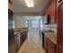 Modern kitchen with stainless steel appliances, dark cabinets, and granite countertops, providing a sleek and functional space at 8343 Bella Tierra Ct # 8343, Davenport, FL 33896