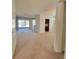Spacious living room with plush carpeting, ample natural light, and a view of the screened lanai at 8343 Bella Tierra Ct # 8343, Davenport, FL 33896
