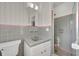 Clean bathroom with gray tile, pink accents, and updated vanity at 10 Madera Rd, Debary, FL 32713