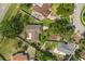 Aerial view showing the property's fenced yard, mature trees, and proximity to neighborhood streets at 1608 Bomi Cir, Winter Park, FL 32792