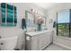 Bright bathroom featuring a double vanity with a gray countertop and modern fixtures at 1608 Bomi Cir, Winter Park, FL 32792