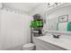 Bathroom with a shower and tub combo, gray tile, and modern fixtures at 1608 Bomi Cir, Winter Park, FL 32792