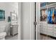 Bathroom with gray vanity, mosaic tile floors, and walk-in closet in the background at 1608 Bomi Cir, Winter Park, FL 32792
