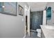 Modern bathroom featuring a walk-in shower with textured tile and stylish fixtures at 1608 Bomi Cir, Winter Park, FL 32792