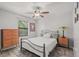 Cozy bedroom with neutral walls, wooden furniture, and natural light from the window at 1608 Bomi Cir, Winter Park, FL 32792