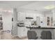 Open-concept kitchen with breakfast bar, white cabinets, and stainless steel appliances at 1608 Bomi Cir, Winter Park, FL 32792