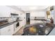 Well-lit kitchen featuring white appliances, white cabinetry, and wooden floors at 1608 Bomi Cir, Winter Park, FL 32792