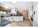 Open concept kitchen with white cabinets, wooden floors, and access to other rooms at 1608 Bomi Cir, Winter Park, FL 32792