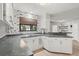 Bright kitchen with white cabinets, dark countertops, and a charming wallpaper accent wall at 1608 Bomi Cir, Winter Park, FL 32792