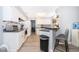 Bright kitchen featuring white cabinetry, stainless appliances, and breakfast bar seating at 1608 Bomi Cir, Winter Park, FL 32792