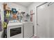 Laundry room featuring a washer, dryer, wire rack shelving, and door to the side at 1608 Bomi Cir, Winter Park, FL 32792