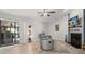 Living room with fireplace, ceiling fan, modern floors, and sliding glass door at 1608 Bomi Cir, Winter Park, FL 32792