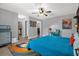 The main bedroom includes colorful decor, a ceiling fan, a bed and hard wood flooring at 1608 Bomi Cir, Winter Park, FL 32792