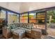 Enclosed sunroom with sliding glass windows, and a wicker style couch at 1608 Bomi Cir, Winter Park, FL 32792