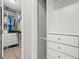 Bright walk-in closet with white shelving, drawers, and ample storage space for clothes and accessories at 1608 Bomi Cir, Winter Park, FL 32792